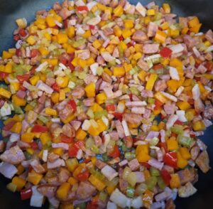 onion, celery, carrot, capsicum, bacon, chorizo in fry pan